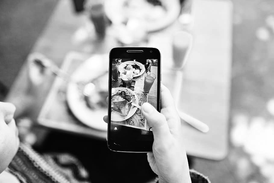 person taking picture of food